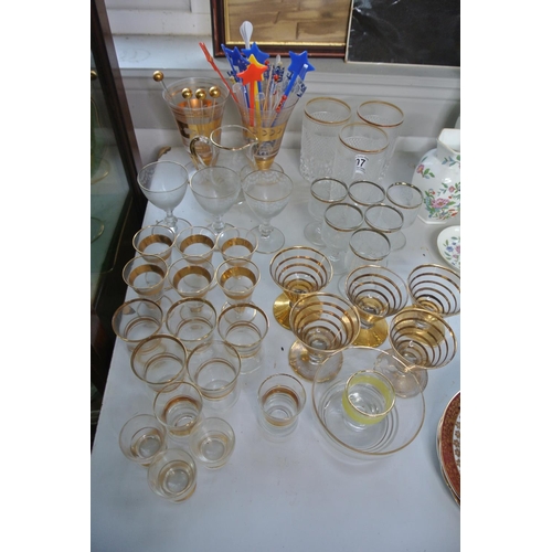 307 - A large lot of vintage gilted glassware including four glass cocktail stirrers