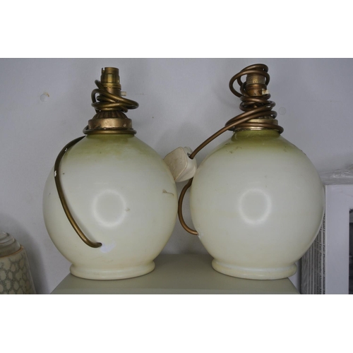 426 - A stunning pair of antique hand painted glass lamp bases with rural scenes.