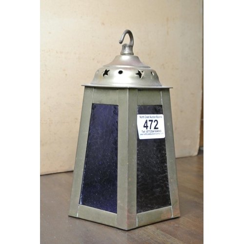 472 - A brass lantern with coloured glass panels