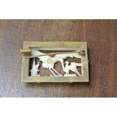 481 - A vintage carved bone brooch with and oriental scene