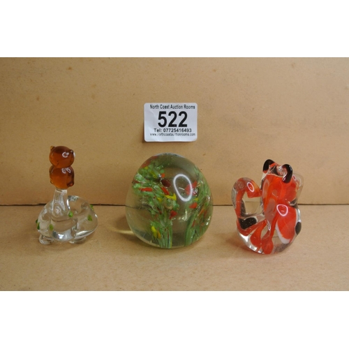 522 - A collection of three glass paper weights.