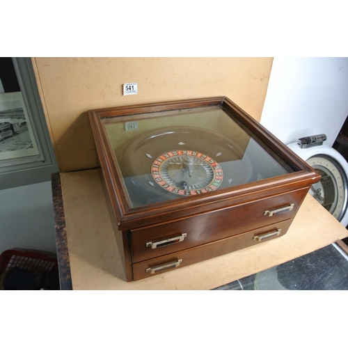 541 - A vintage cased roulette wheel to include chips and tokens.