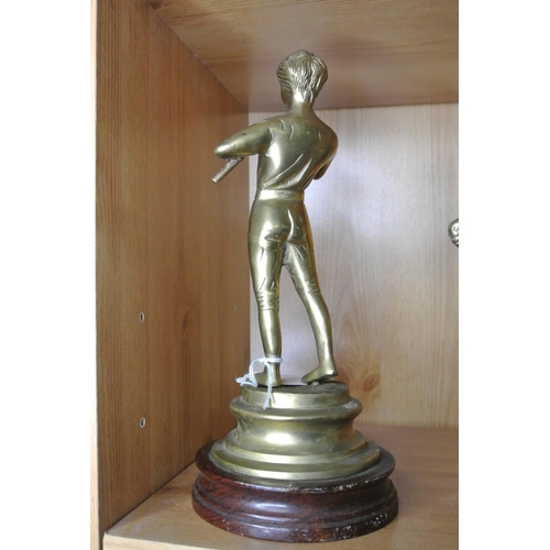 124 - A brass figure modelled as man with flute.