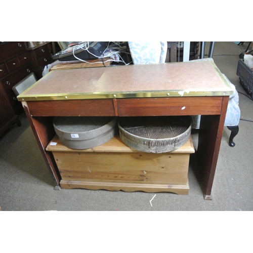 223 - A wooden desk with brass trim & drawers.