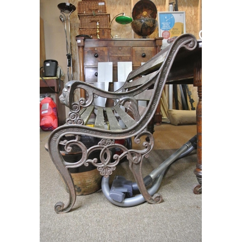 235 - A garden bench with cast iron lion mask ends, in need of restoration.