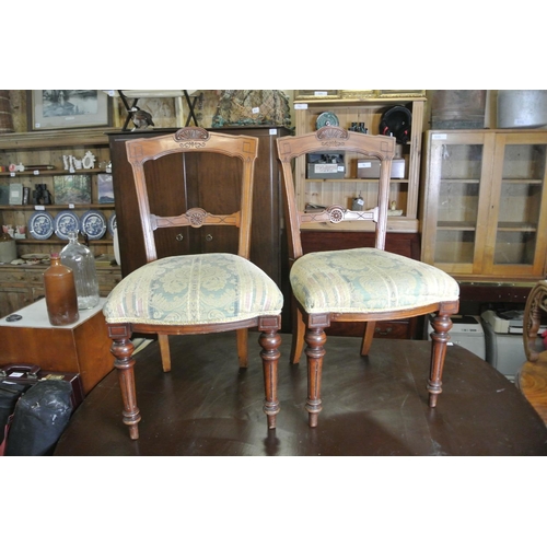 252 - A stunning pair of antique dining chairs with decoratively carved frames.