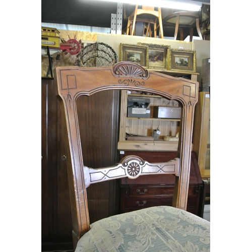 252 - A stunning pair of antique dining chairs with decoratively carved frames.