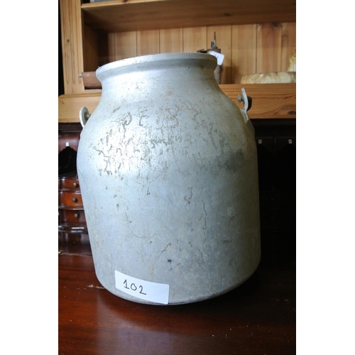 102 - A small metal creamery can/ planter.