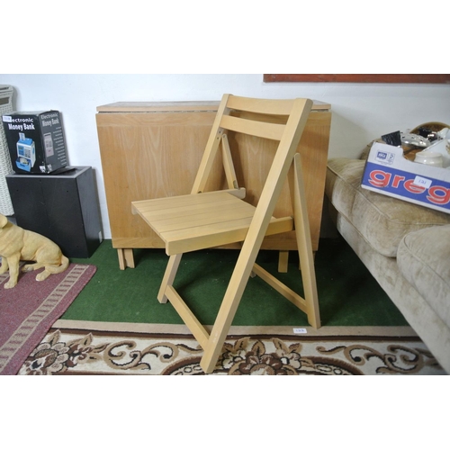 118 - A drop leaf kitchen table with three folding chairs