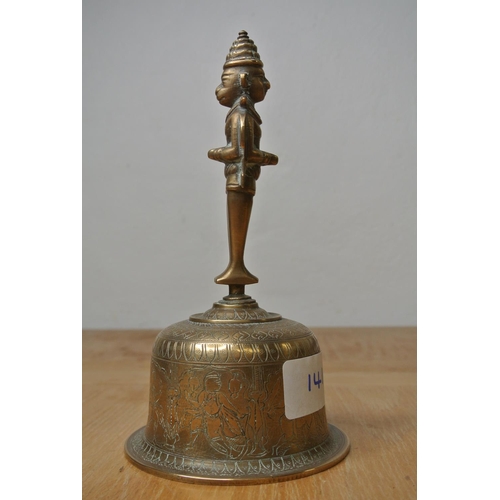 141 - An Indian brass bell with engravings