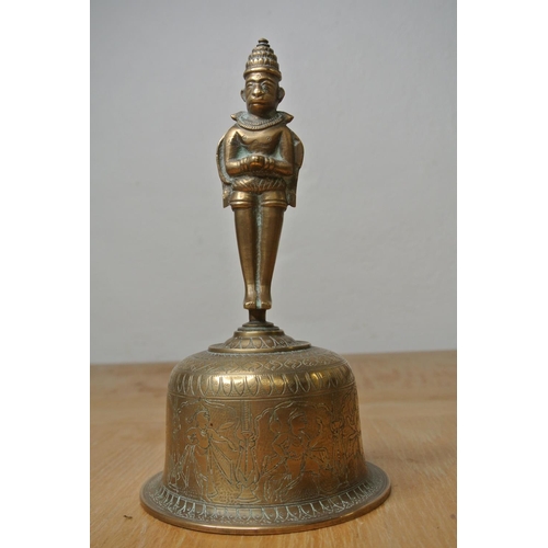 141 - An Indian brass bell with engravings