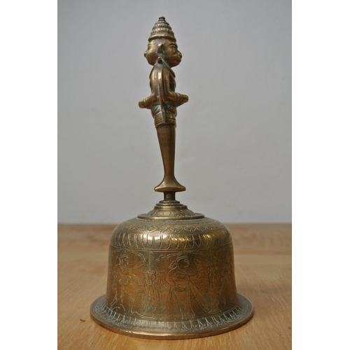 141 - An Indian brass bell with engravings