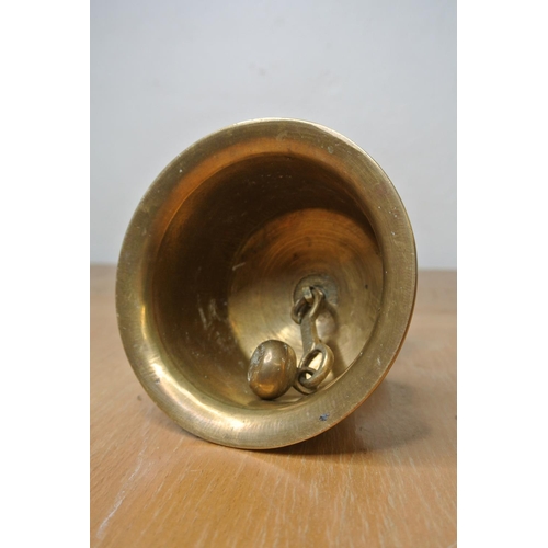 141 - An Indian brass bell with engravings