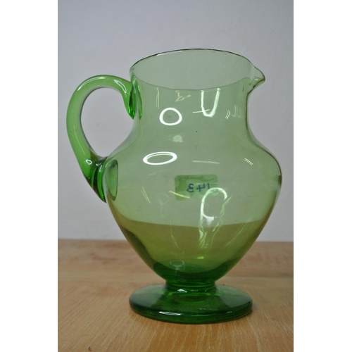 143 - An antique green glass water jug