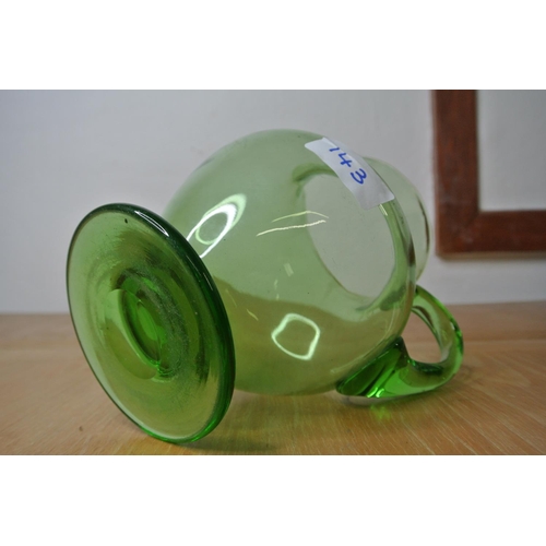 143 - An antique green glass water jug