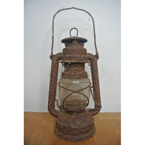 254 - A hurricane oil lamp, hanging scales and a vintage trap