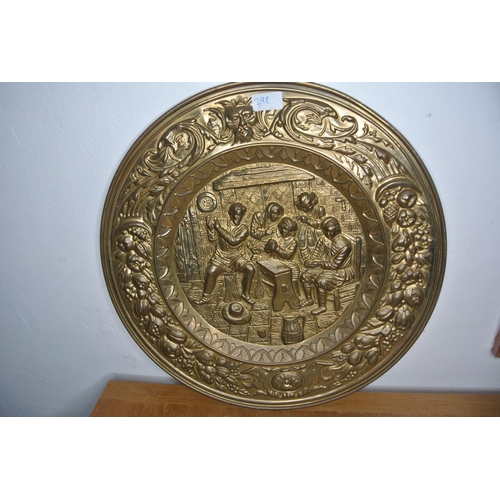 298 - A large heavily detailed brass charger depicting a old tavern scene