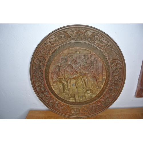 298 - A large heavily detailed brass charger depicting a old tavern scene