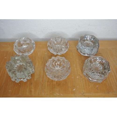 328 - A large collection of cut glass and crystal items to include jugs, decanters, lidded pots and more