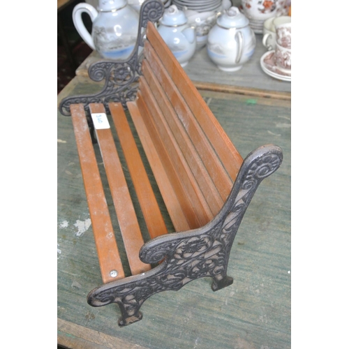 340 - A miniature garden bench with cast iron ends