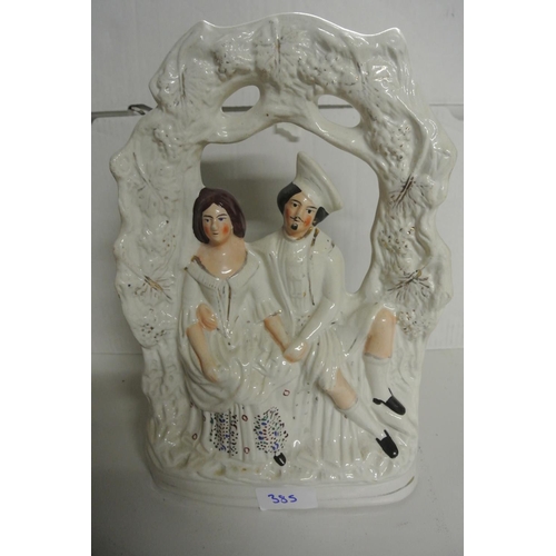 385 - A large antique Staffordshire figure depicting two lovers under an arch