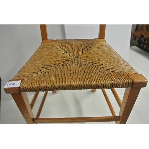 402 - An antique bedroom chair with woven seat