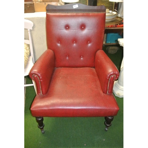 457 - An antique buttoned back leather bound fireside or library armchair