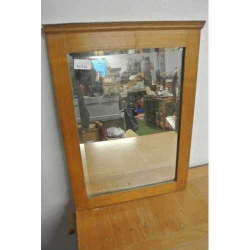 474 - An antique wood framed mirror