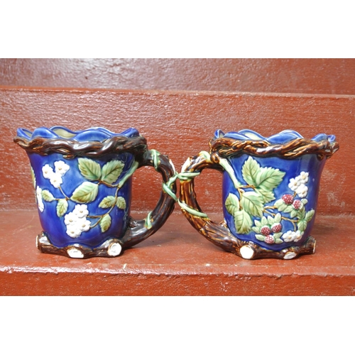 117 - A pair of decorative jugs.