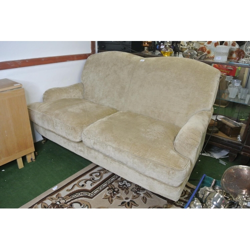 120 - A two seater fabric settee on casters