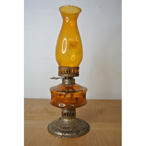 128 - An amber oil lamp