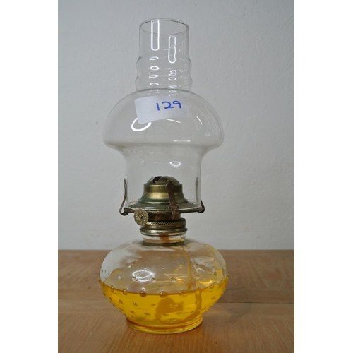 129 - A clear glass oil lamp