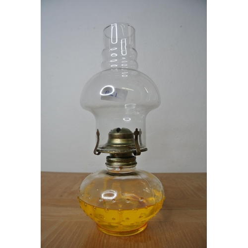 129 - A clear glass oil lamp