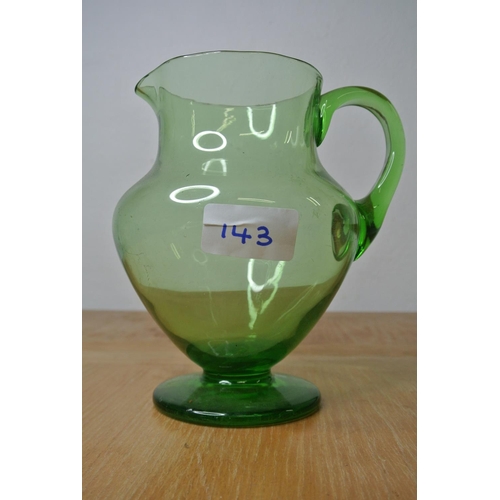 143 - An antique green glass water jug