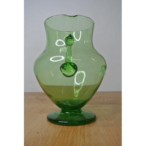 143 - An antique green glass water jug