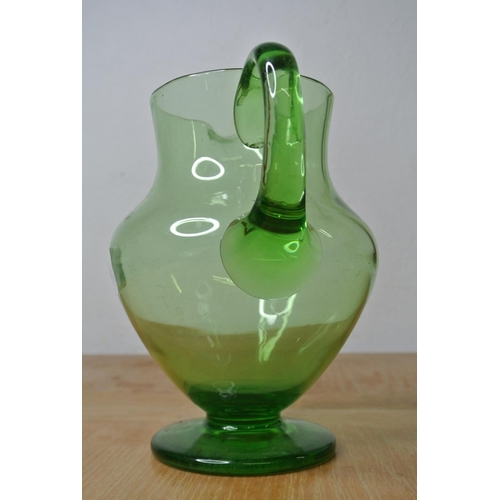 143 - An antique green glass water jug