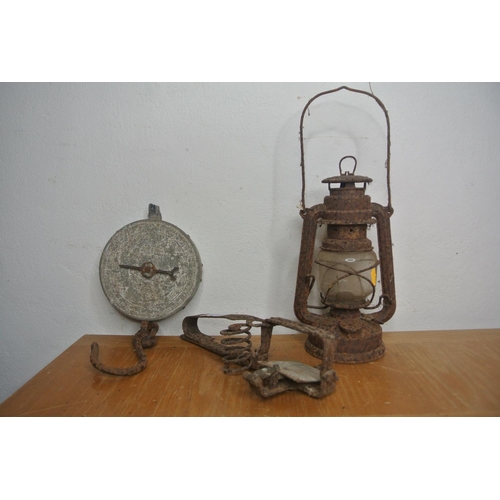 254 - A hurricane oil lamp, hanging scales and a vintage trap