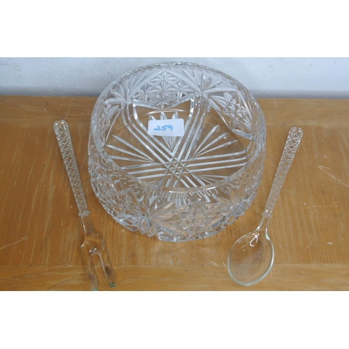 259 - A cut glass bowl with glass serving fork and spoon