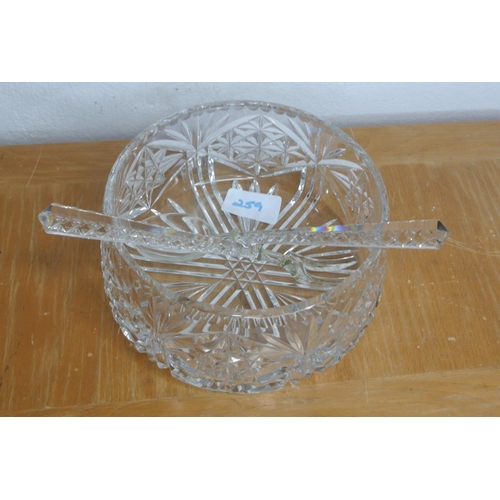 259 - A cut glass bowl with glass serving fork and spoon