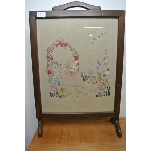 321 - A stunning antique fire screen with needlepoint tapestry depicting a lady in a garden