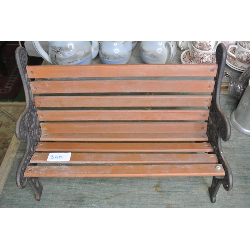 340 - A miniature garden bench with cast iron ends