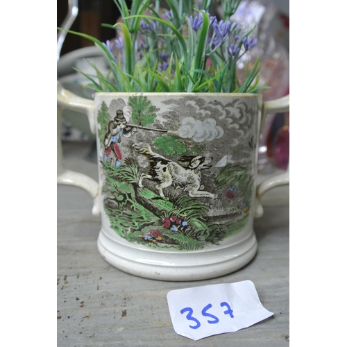 357 - An antique double-handled bouillon cup with hand painted hunting scenes