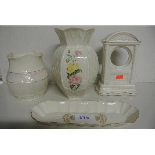 396 - A collection of Belleek pieces to include two vases, a model of a clock and a dish