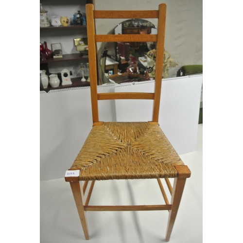 402 - An antique bedroom chair with woven seat