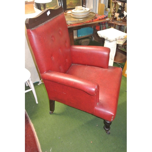 457 - An antique buttoned back leather bound fireside or library armchair