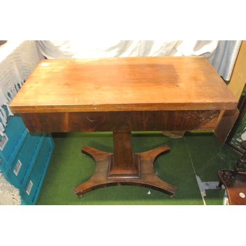 462 - An antique pedestal fold-over tea table