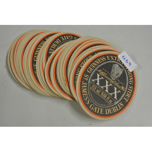 469 - A large collection of vintage Guinness Triple X promotional coasters