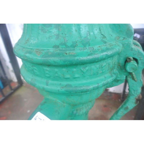 475 - An antique cast iron cow tail pump painted green, reading 'SUCCESSORS BALLYMENA'