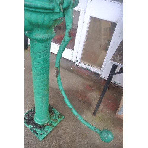 475 - An antique cast iron cow tail pump painted green, reading 'SUCCESSORS BALLYMENA'