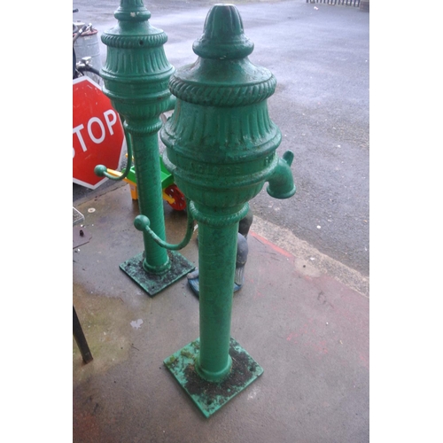 475 - An antique cast iron cow tail pump painted green, reading 'SUCCESSORS BALLYMENA'